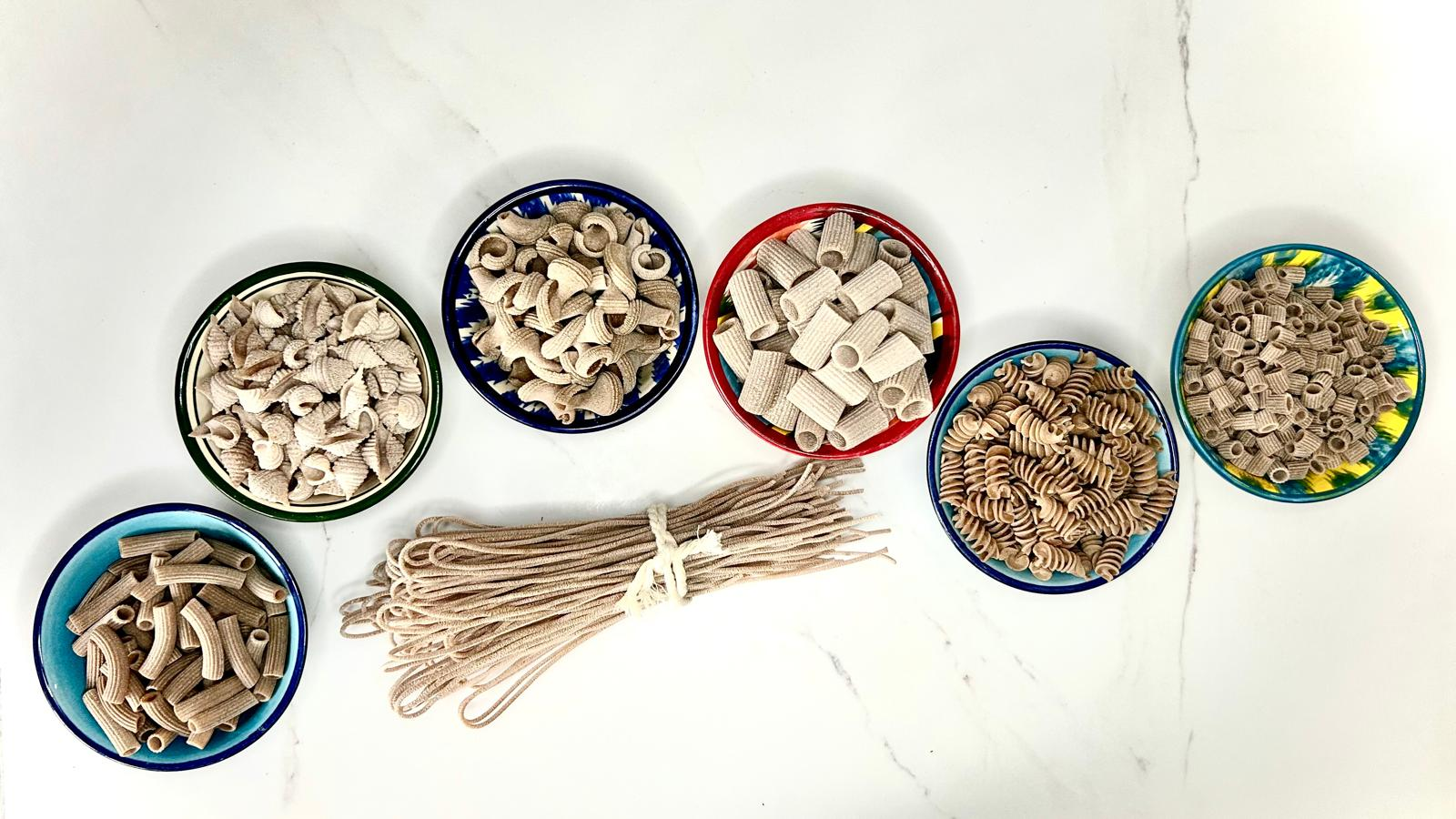 Assorted types ofwholegrain pasta in bowls on a white background from the discovery bundle from carleschi